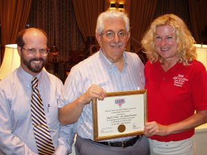 Gerry Cantor (center) receives officials service reward from Pat Lavelle and Laurie Boemker at USATF-NE annual meeting.